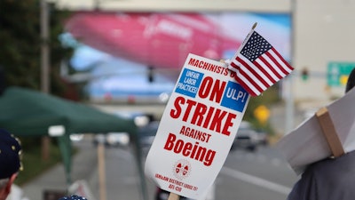 A strike sign is waved on the union machinist picket line near Boeing's factory in Everett, Washington.