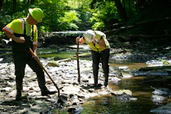 Environmental Protection Agency workers work in Leslie Run in East Palestine, Ohio, June 12, 2024.