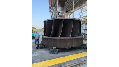 ORNL’s Jay Tiley inspects a hydroelectric runner from TVA’s Cherokee Dam. ORNL is partnering with TVA and others to develop a process to produce large metal components like this for clean energy applications.