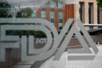 A U.S. Food and Drug Administration building is seen behind FDA logos at a bus stop on the agency's campus in Silver Spring, Md., on Aug. 2, 2018.
