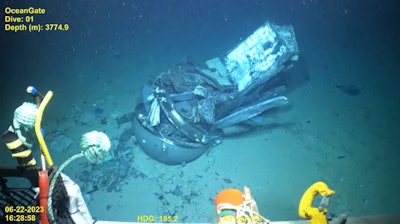 This June 2023 United States Coast Guard still frame from video provided by Pelagic Research Services, shows remains of the Titan submersible, center, on the floor of the Atlantic Ocean.