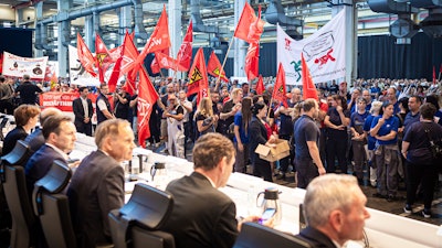 Employees protest before the start of a works meeting in a hall at the VW plant in Wolfsburg, Wednesday, Sept. 4, 2024.