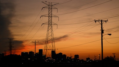 Electrical power lines string across the landscape near downtown Sunday, Aug. 11, 2024, in Nashville, Tenn, as Nashville Electric Service distributes power to surrounding communities and is supplied their electricity from The Tennessee Valley Authority.