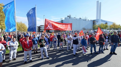 Volkswagen employees gather at the factory gate as Volkswagen's employee council says the automaker plans to close at least 3 German plants, in Zwickau, Germany, Monday, Oct. 28, 2024.