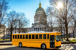 A GreenPower school bus parked in front of the West Virginia State Capitol.