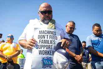 Longshoremen bow for a prayer during a strike at the Bayport Container Terminal on Tuesday, Oct. 1, 2024, in Houston.