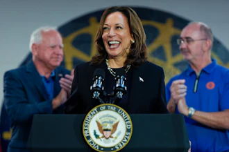 Democratic presidential nominee Vice President Kamala Harris, with Democratic vice presidential nominee Minnesota Gov. Tim Walz, left, and UAW President Shawn Fain, speaks at a campaign rally at UAW Local 900, Aug. 8, 2024, in Wayne, Mich.