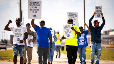 Longshoremen walk the picket line at the Barbours Cut Container Terminal during the first day of a dockworkers strike on Tuesday, Oct. 1, 2024, in Houston.