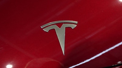 The logo of Tesla car is pictured at the Paris Auto Show, in Paris, Monday, Oct. 14, 2024.
