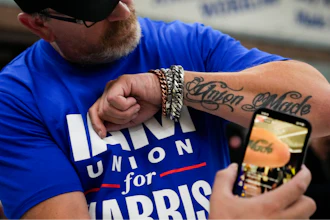 Ed Lutgen shows off his tattoo while waiting to hear the results of the union vote on a new contract offer from Boeing, Monday, Nov. 4, 2024, at IAM District 751 Union Hall in Seattle.