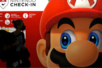 A traveler walks past an advertisement featuring a Nintendo character at Narita airport in Narita near Tokyo, on June 10, 2022.
