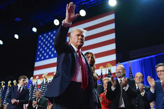 Republican presidential nominee former President Donald Trump waves as he walks with former first lady Melania Trump at an election night watch party at the Palm Beach Convention Center, Wednesday, Nov. 6, 2024, in West Palm Beach, Fla.