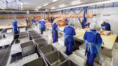 Meat cutting in a slaughterhouse.