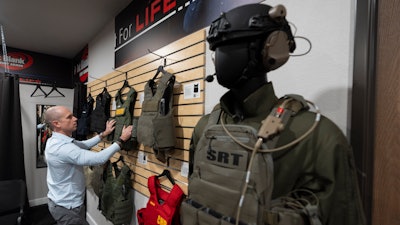 Veteran and business owner Jackson Dalton arranges protective gear at the Black Box Safety offices, Thursday, Nov. 7, 2024, in El Cajon, Calif.