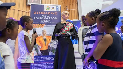 Sophia, the humanoid robot, responds to questions from children at the University of Zimbabwe, Harare, Friday, 13 Dec. 2024.