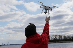 In this April 29, 2018, file photo, a drone operator helps to retrieve a drone after photographing over Hart Island in New York.