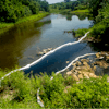 City, Genesee County and state of Michigan agencies respond to an oil spill in the Flint River, Wednesday, June 15, 2022.