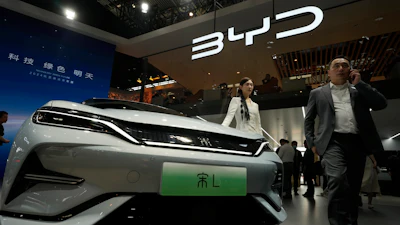 A model poses near the BYD Song L EV car during Auto China 2024 held in Beijing, April 25, 2024.