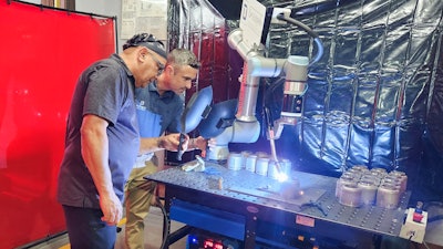 Production manager Camilo Aguilar (left) and CEO Justin Montes, DeAngelo Marine Exhaust, watch how Hirebotics’ Cobot Welder MIG welds at 20 inches per minute, a 10x boost in production compared to manual TIG welding.