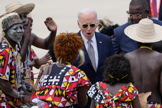 President Joe Biden watches a traditional dance after arriving at Catumbela airport in Angola on Wednesday, Dec. 4, 2024.