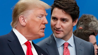U.S. President Donald Trump, left, and Canadian Prime Minister Justin Trudeau talk prior to a NATO round table meeting at The Grove hotel and resort in Watford, Hertfordshire, England, Dec. 4, 2019.