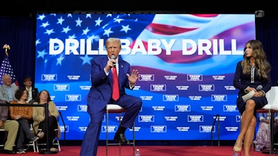 Republican presidential nominee former President Donald Trump speaks at a campaign town hall at the Greater Philadelphia Expo Center & Fairgrounds, Oct. 14, 2024, in Oaks, Pa., as moderator South Dakota Gov. Kristi Noem listens.