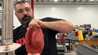 Wilson Sporting Goods football factory employee Derek Gibson operates a machine that turns the football for the upcoming Super Bowl matchup between the Philadelphia Eagles and the Kansas City Chiefs from inside-out, Monday, January 27, 2025, in Ada, Ohio.