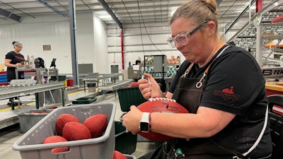 Wilson Sporting Goods football factory employee Nicole Rainsburg inspects the Super Bowl game balls before they are ready to be shipped Monday, January 27, 2025, in Ada, Ohio.
