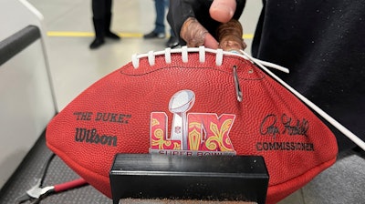 An employee at the Wilson Sporting Goods football factory laces one of the official Super Bowl game balls Monday, January 27, 2025, in Ada, Ohio.