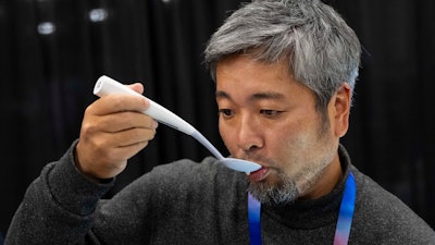 Kiyohiro Izumo uses the Kirin Electric Salt spoon which intensifies salt flavor by flowing a mild electric current through the food around the tongue to attract salt towards the tongue, during 2025 CES Unveiled, Sunday, Jan. 5, 2025, in Las Vegas.