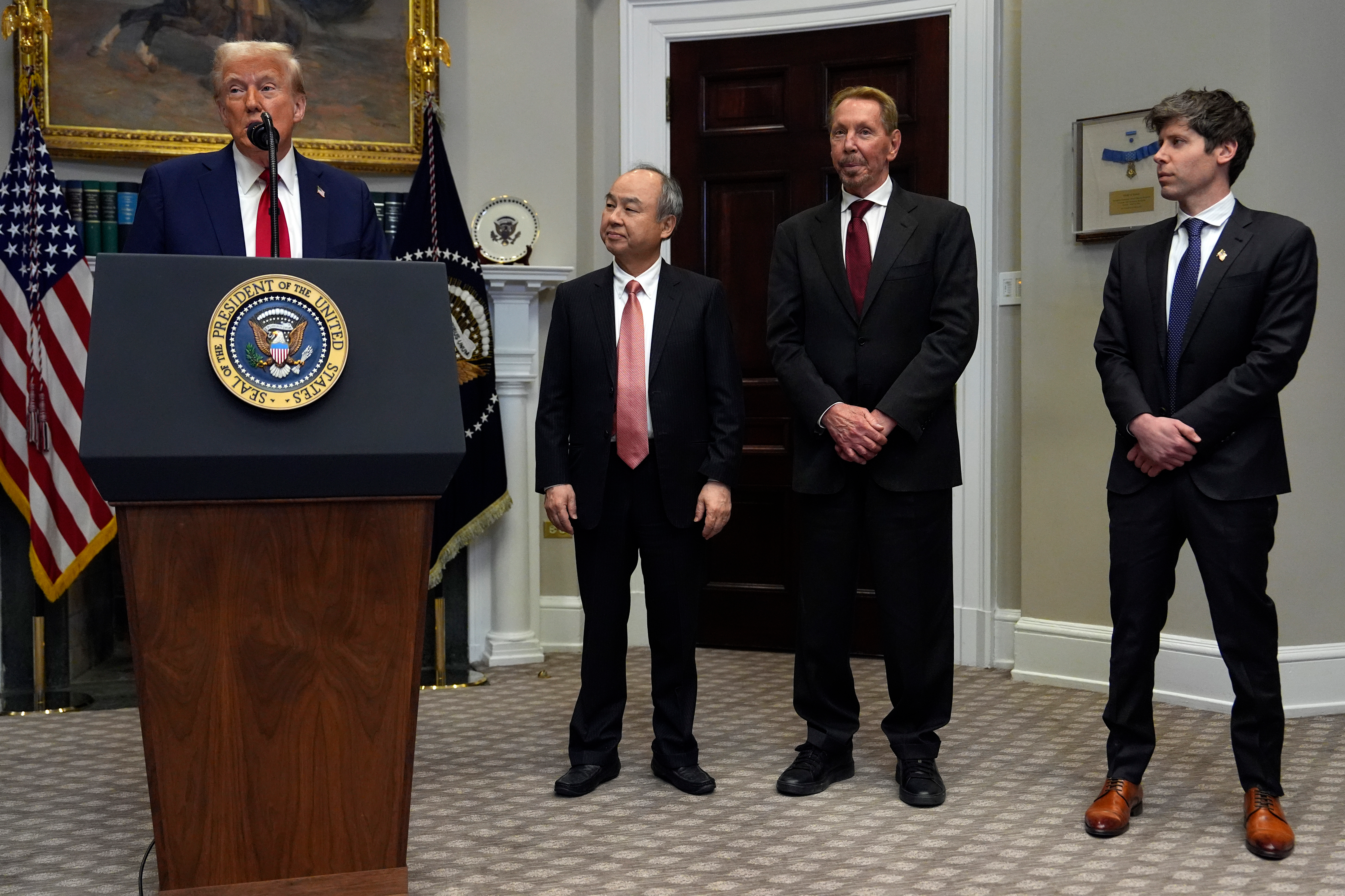 President Donald Trump speaks in the Roosevelt Room at the White House, Tuesday, Jan. 21, 2025, in Washington, as Softbank CEO Masayoshi Son, Oracle chief technology officer Larry Ellison and OpenAI CEO Sam Altman, listen.