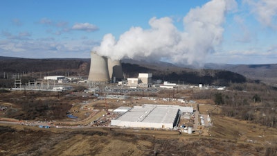 A data center owned by Amazon Web Services, front right, is under construction next to the Susquehanna nuclear power plant in Berwick, Pa., on Tuesday, Jan. 14, 2024.