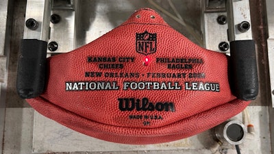 A machine imprints the names of the Philadelphia Eagles and the Kansas City Chiefs onto a football for the upcoming Super Bowl matchup at the Wilson Sporting Goods football factory, Monday, January 27, 2025, in Ada, Ohio.