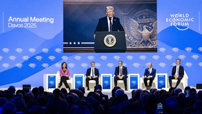 U.S. President Donald J. Trump is shown on screens as he addresses via remote connection a plenary session in the Congress Hall, during the 55th annual meeting of the World Economic Forum (WEF), in Davos, Switzerland, Thursday, Jan. 23, 2025.