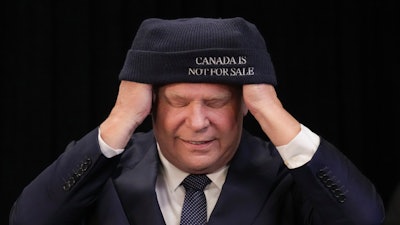 Ontario Premier Doug Ford dons a toque following a press conference with Chief Sonny Gagnon of Aroland First Nation at Queens Park, the provincial legislature, in Toronto, Tuesday, Jan. 28, 2025.