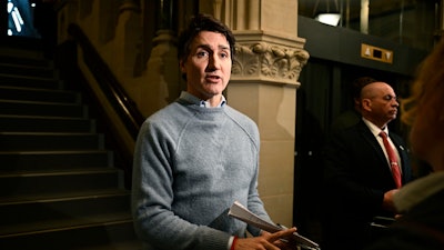 Canadian Prime Minister Justin Trudeau answers questions from reporters as he makes his way to a meeting of the Liberal caucus in West Block on Parliament Hill in Ottawa, on Thursday, Jan. 23, 2025.