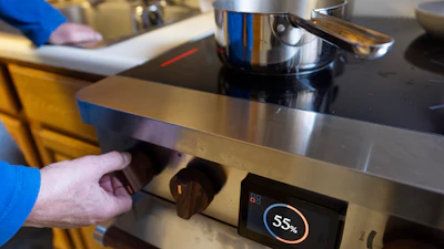 Ed Yaker boils water on a Copper stove, an electric induction stove, Feb. 10, 2025, New York.