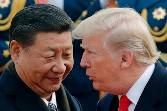 U.S. President Donald Trump, right, chats with Chinese President Xi Jinping during a welcome ceremony at the Great Hall of the People in Beijing on Nov. 9, 2017.