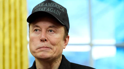 Elon Musk listens during an event in the Oval Office with President Donald Trump at the White House, Tuesday, Feb. 11, 2025, in Washington.