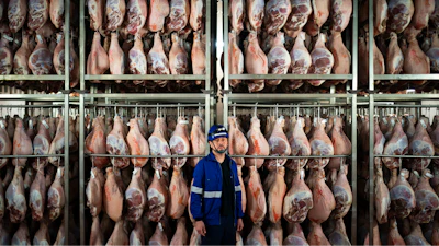 Víctor Razuri, 41, from Peru, poses in a ham drying plant in Guissona, Lleida, Spain, Feb. 20, 2025.
