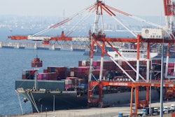 A container ship is loaded and unloaded at a container terminal at a port of Kawasaki near Tokyo on March 9, 2022.