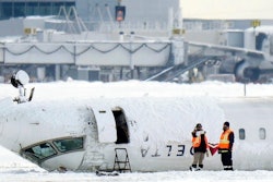 A Delta Air Lines plane lies upside down at Toronto Pearson Airport on Tuesday, Feb. 18, 2025.