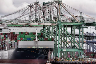 A sailboat passes a cargo ship unloading containers at the port of Los Angeles in San Pedro on Thursday, June 15, 2023.