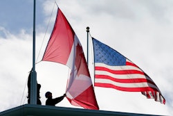 Washington State Park workers put up a new Canadian flag atop the Peace Arch in Peace Arch Historical State Park, Nov. 8, 2021, Blaine, Wash.