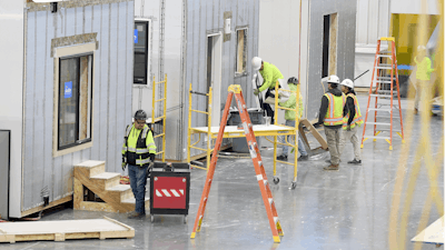 Workers construct modular homes at the Fading West factory in Buena Vista, Colo., on Feb. 19, 2025.