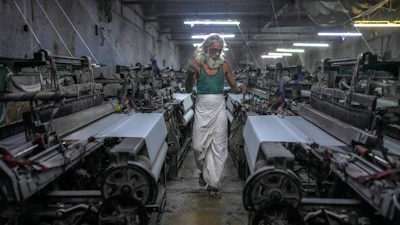 Abdul Sattar, 70, operates a power loom at a workshop in Bhiwandi, India, Feb. 25, 2025.