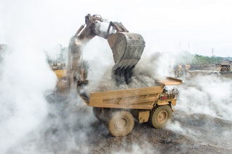 A backhoe loads material into a mining dump truck at a nickel mining operation in South Sulawesi, Indonesia.