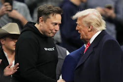 Elon Musk, left, shakes hands with President Donald Trump at the finals for the NCAA wrestling championship, Saturday, March 22, 2025, in Philadelphia.