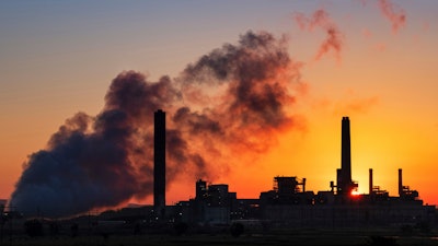 The Dave Johnson coal-fired power plant is silhouetted against the morning sun in Glenrock, Wyo., July 27, 2018.