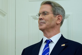 Treasury Secretary Scott Bessent listens as President Donald Trump speaks with reporters as he participates in a ceremonial swearing in of Paul Atkins as chairman of the Securities and Exchange Commission, in the Oval Office of the White House, Tuesday, April 22, 2025, in Washington.